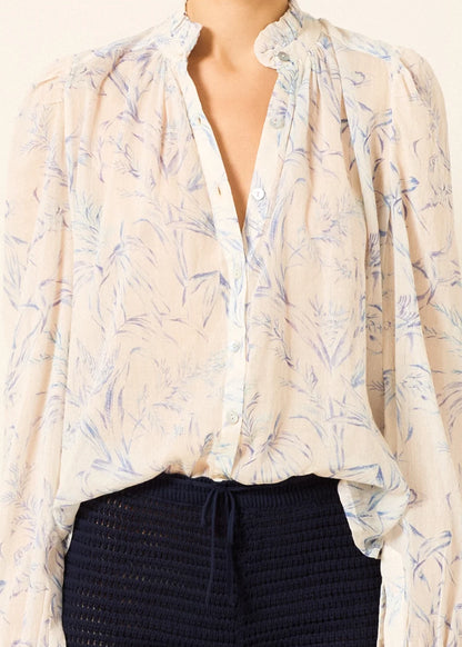 a sheer, long-sleeve button-up blouse by Alix Of Bohemia with a delicate blue and beige floral pattern