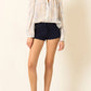 a sheer, long-sleeve button-up blouse by Alix Of Bohemia with a delicate blue and beige floral pattern