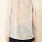 a sheer, long-sleeve button-up blouse by Alix Of Bohemia with a delicate blue and beige floral pattern