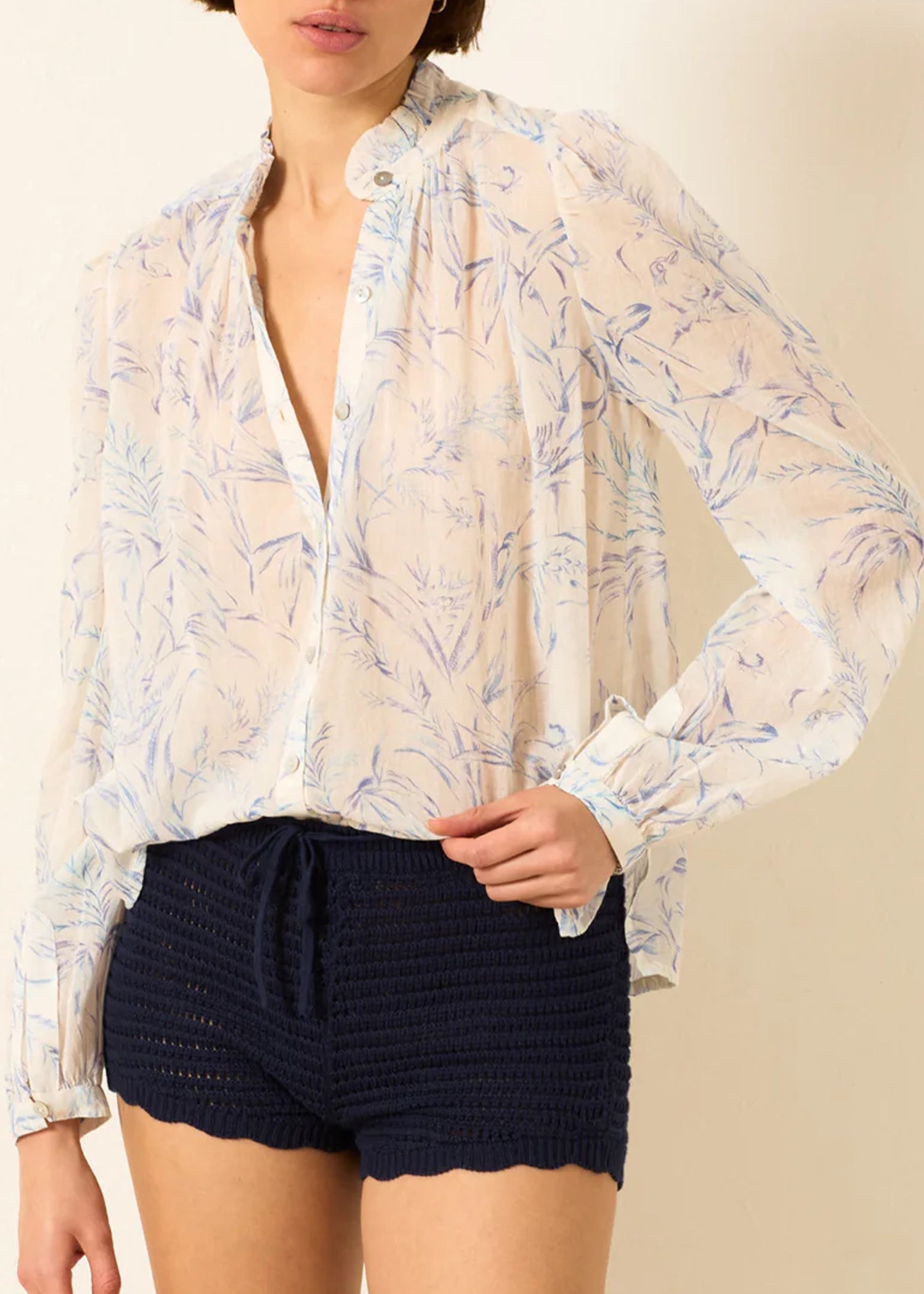 a sheer, long-sleeve button-up blouse by Alix Of Bohemia with a delicate blue and beige floral pattern