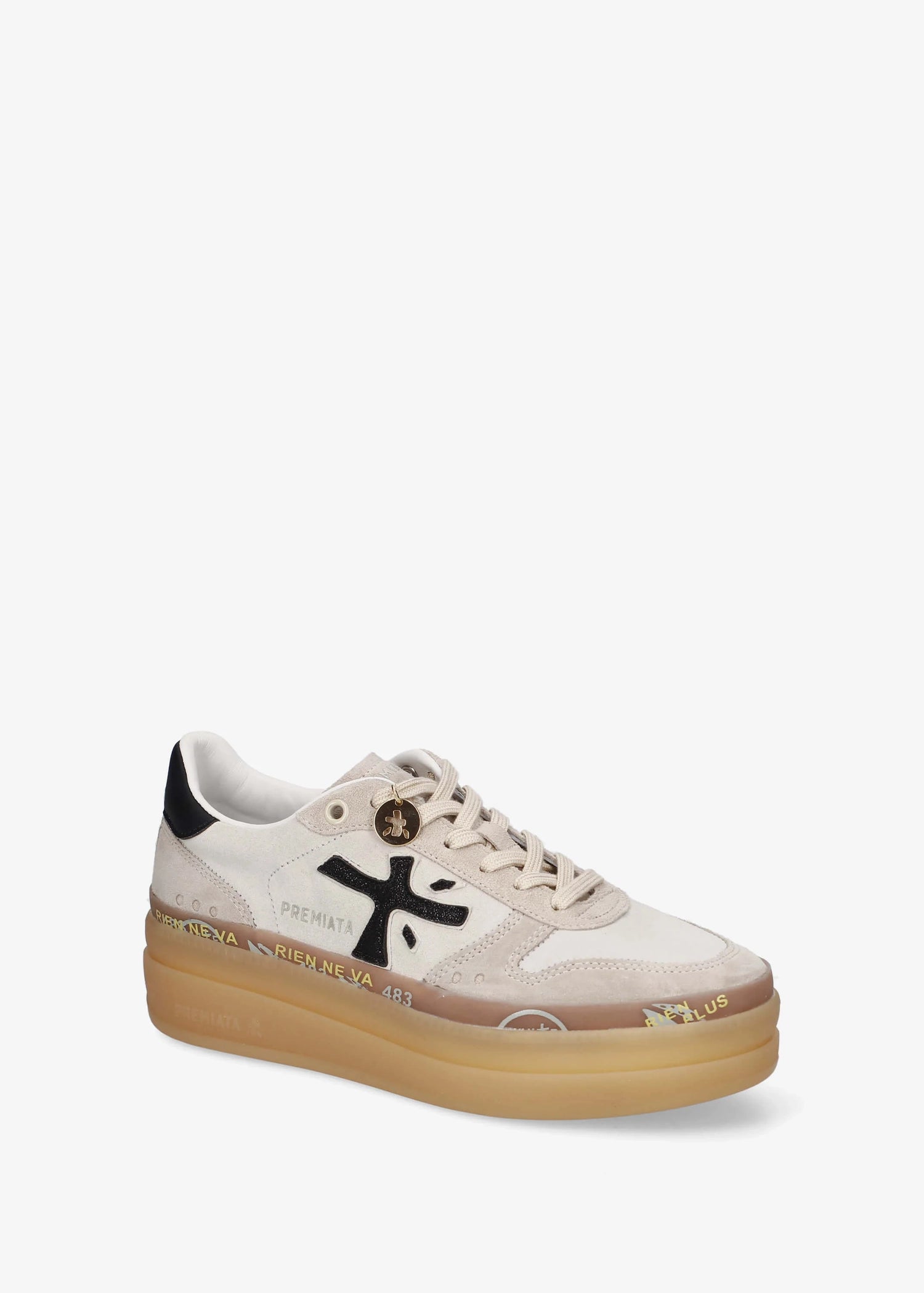 A low-top platform sneaker by Premiata, featuring a cream and beige suede and mesh upper, a black cross logo on the side, gold-tone hardware, and a thick tan gum sole.