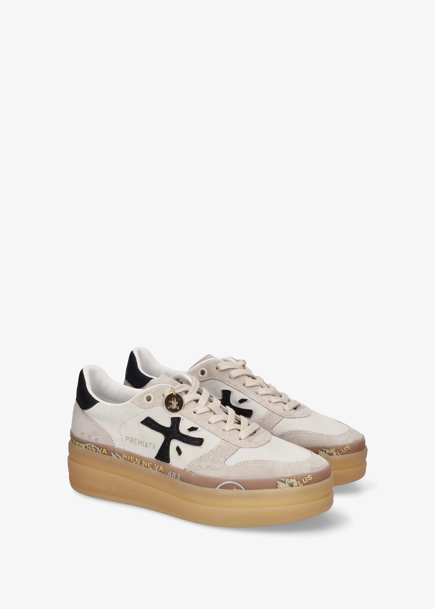 A low-top platform sneaker by Premiata, featuring a cream and beige suede and mesh upper, a black cross logo on the side, gold-tone hardware, and a thick tan gum sole.